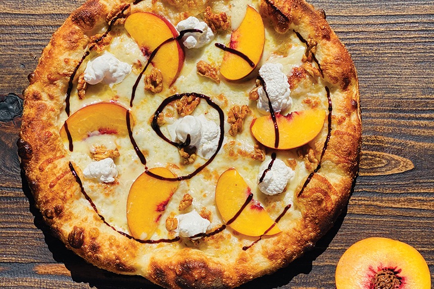Peach pizza on wooden table